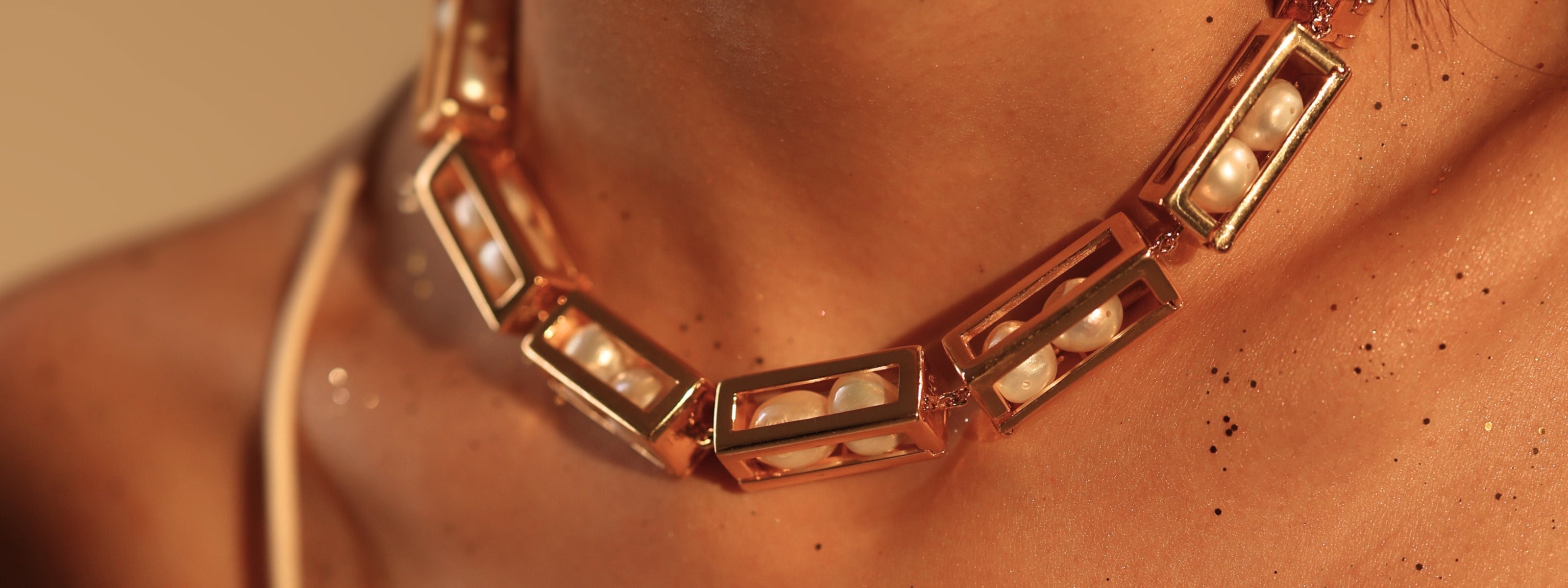 Close-up of a Mhari Mardaani gold-plated silver collar necklace set with caged pearls