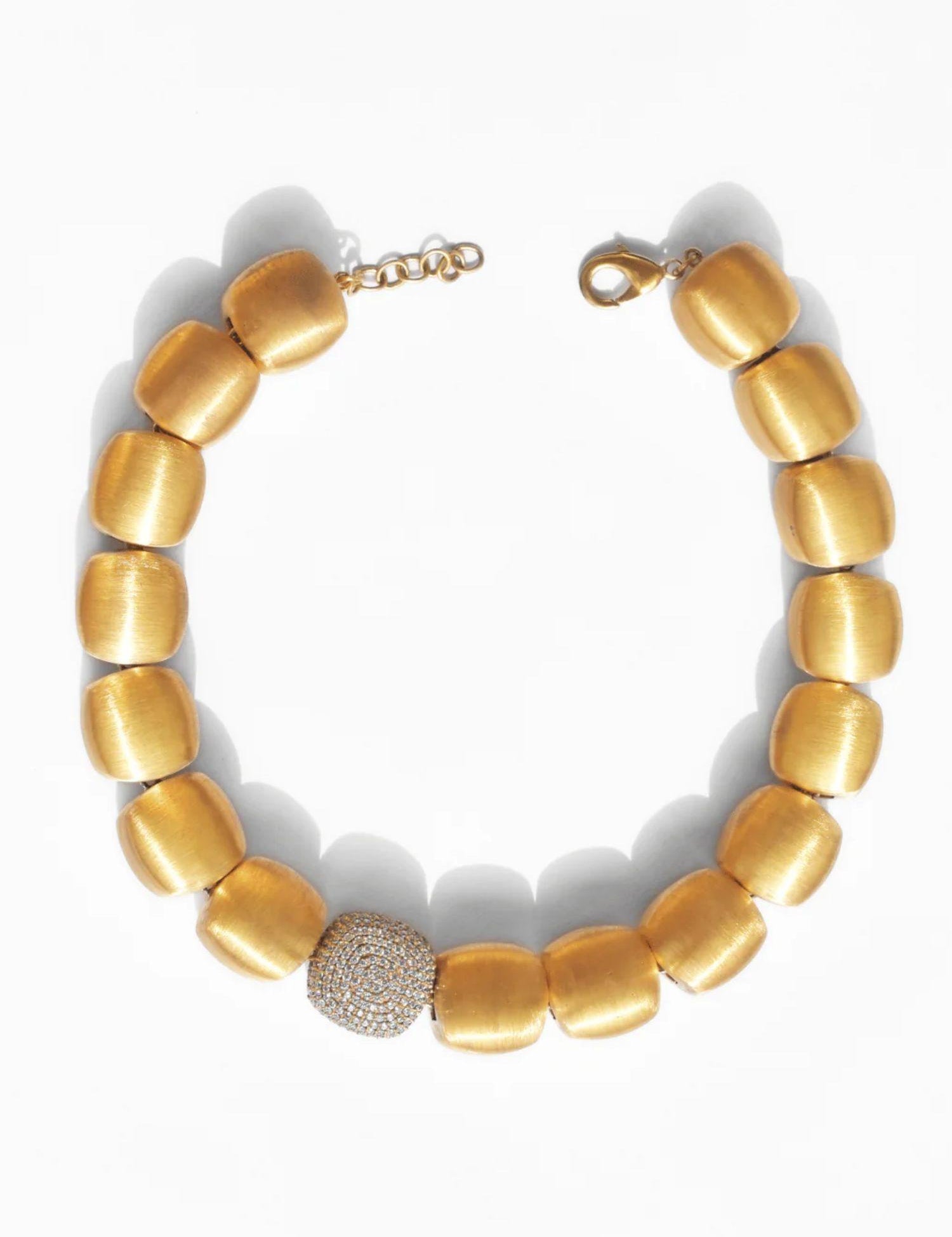 Brushed gold cube necklace with single CZ pave sphere on white background