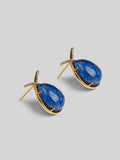 Angled product shot of Aeris deep blue teardrop earrings showing stone texture and gold setting.