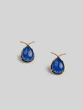 Angled product shot of Aeris deep blue teardrop earrings showing stone texture and gold setting.