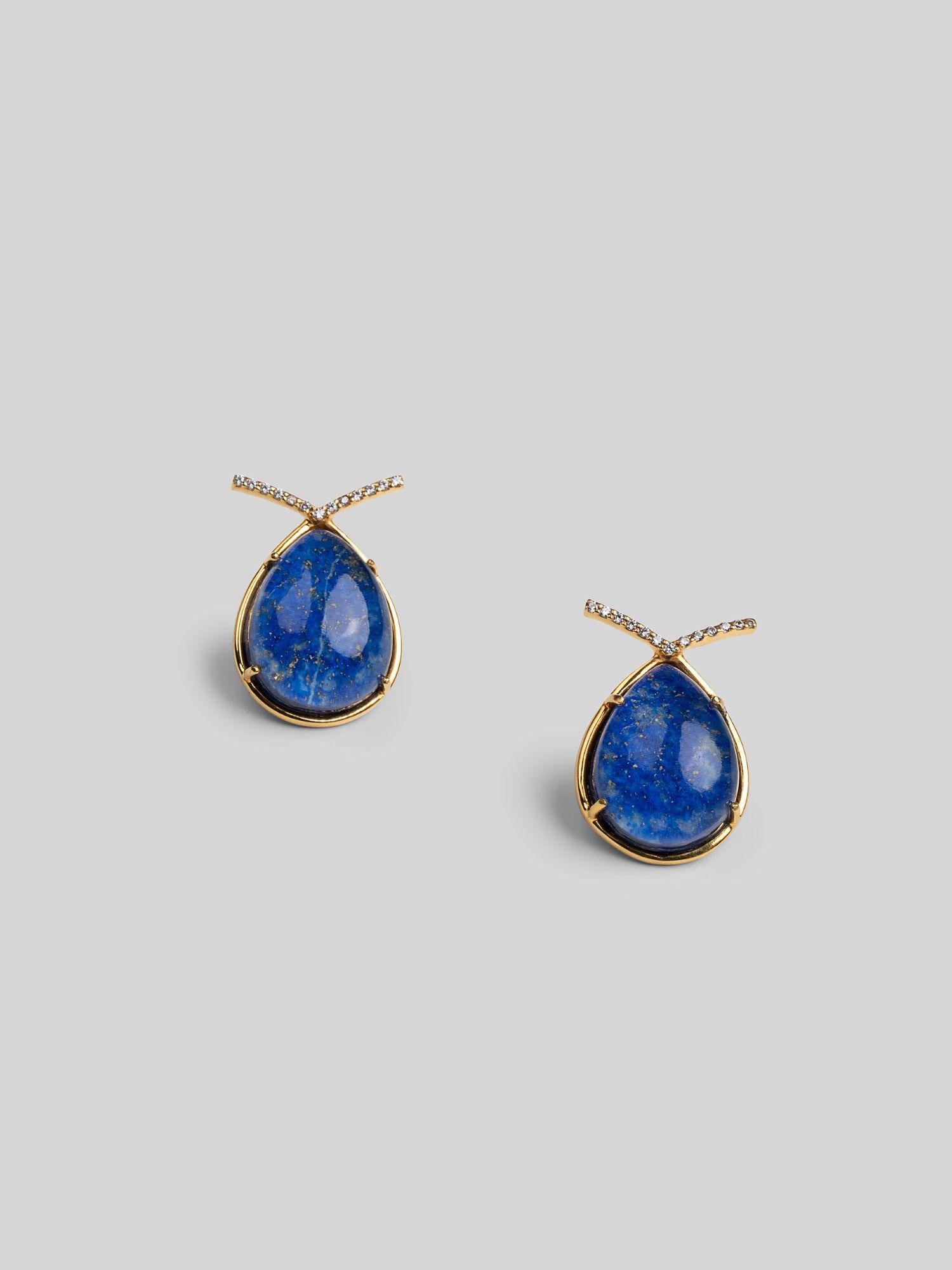 Angled product shot of Aeris deep blue teardrop earrings showing stone texture and gold setting.