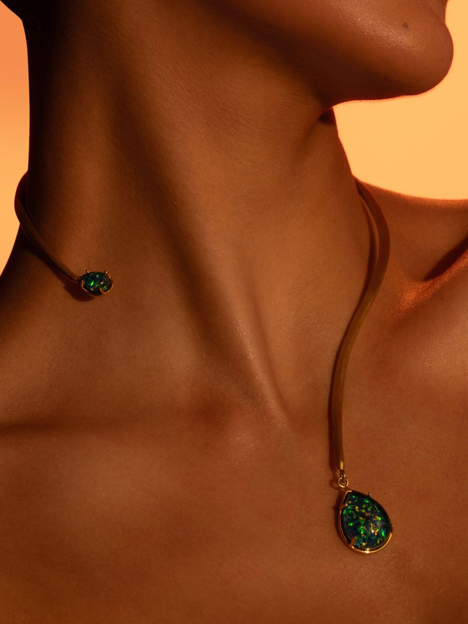 Aeris green opal pendant on open gold bar necklace worn close to neck in warm editorial light