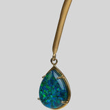 Aeris opal crystal haze teardrop pendant in gold prong setting on open bar necklace, neutral background.