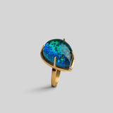 Aeris opal crystal haze teardrop cocktail ring in open 24k gold setting, front angle on neutral background.