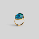 Side view of Aeris opal teardrop ring showing sculptural open gold band and stone setting on neutral background.
