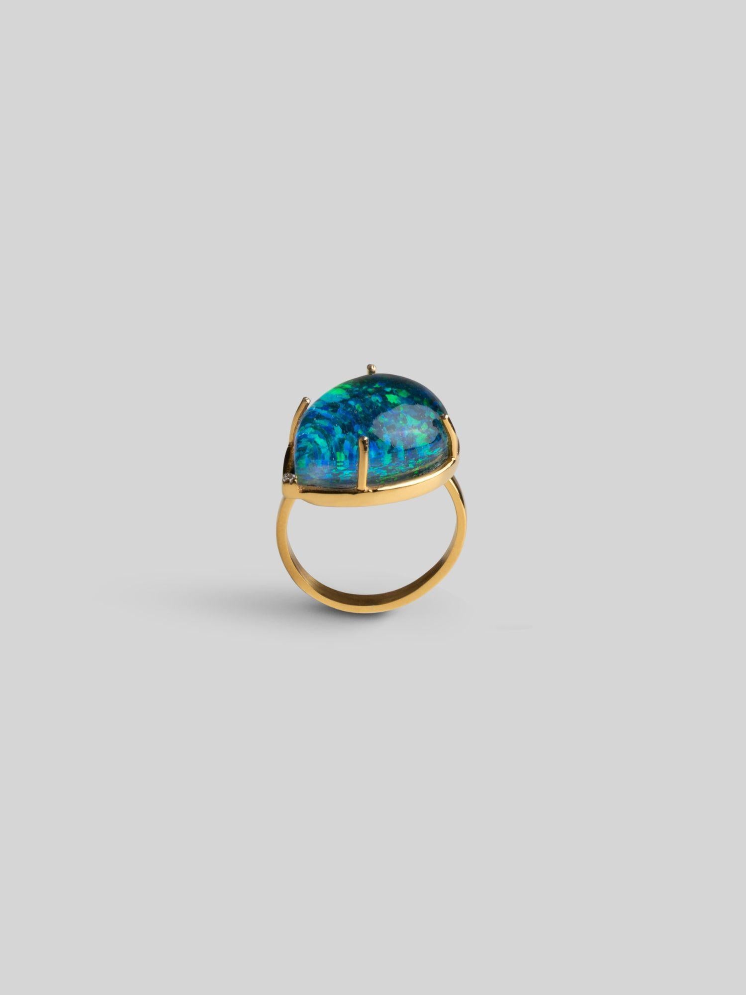 Side view of Aeris opal teardrop ring showing sculptural open gold band and stone setting on neutral background.