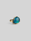 Three-quarter product shot of Aeris green opal cocktail ring in 24k gold on neutral background.
