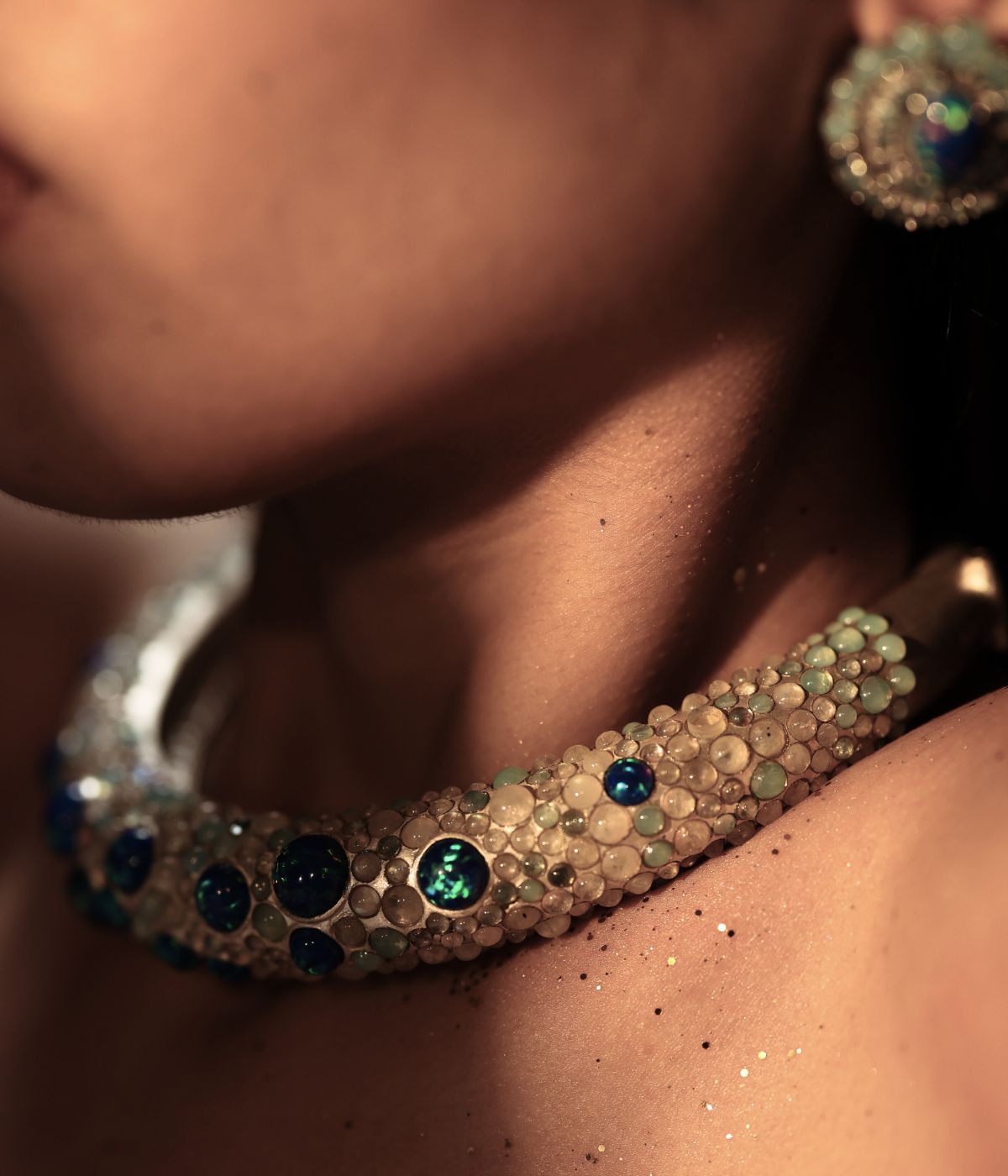 Model wearing sculptural opal and stone collar necklace, Deewani archetype