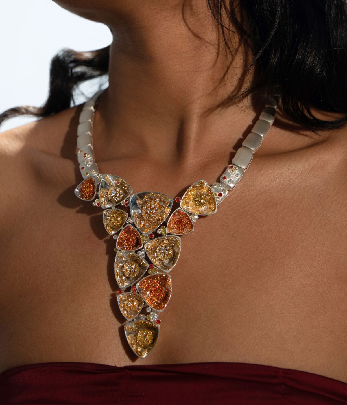 Model wearing bold amber and CZ statement necklace, Maharani archetype