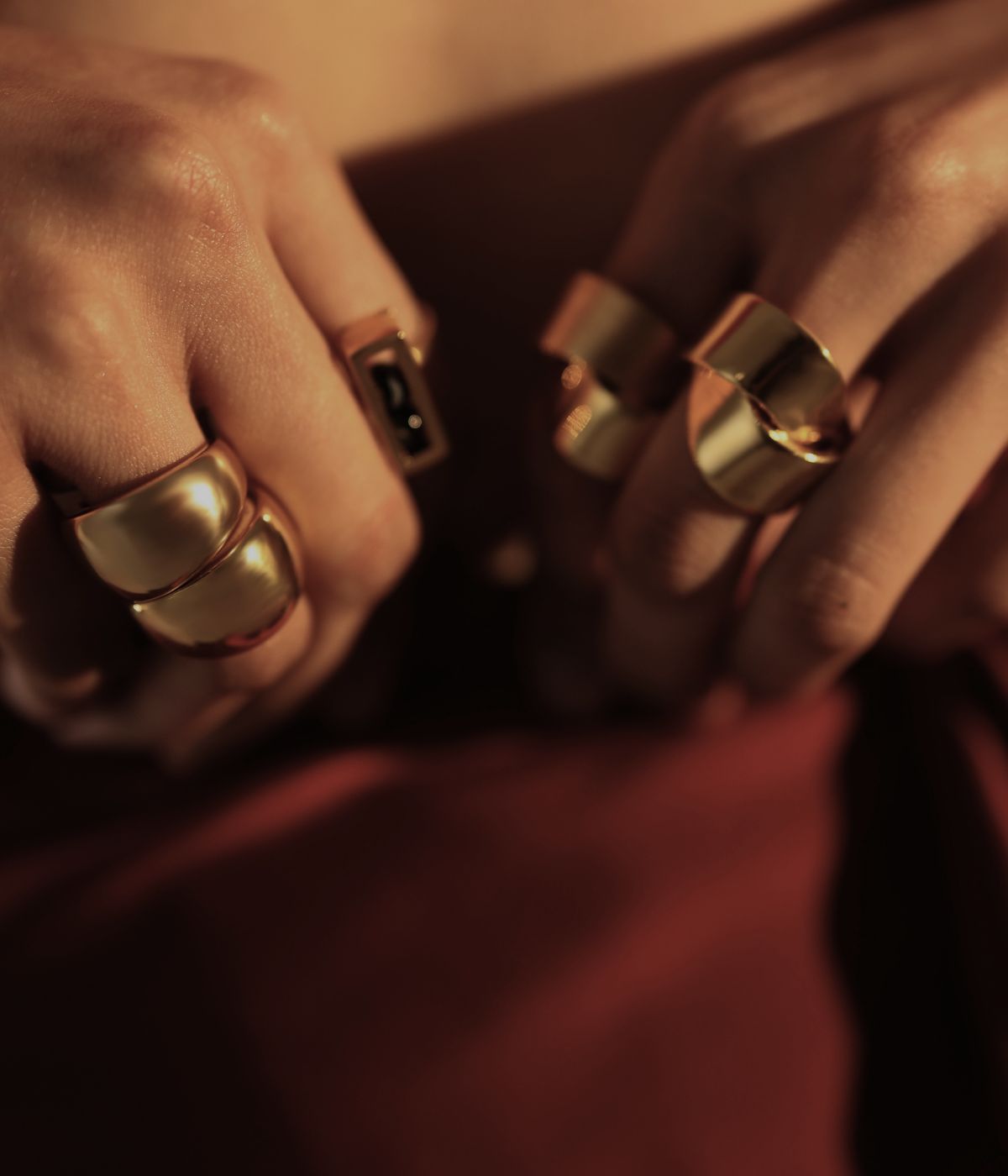 Model wearing stacked sculptural silver rings on multiple fingers, Mardani archetype