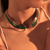 Model wearing Audace malachite collar necklace in warm light, collarbone close-up