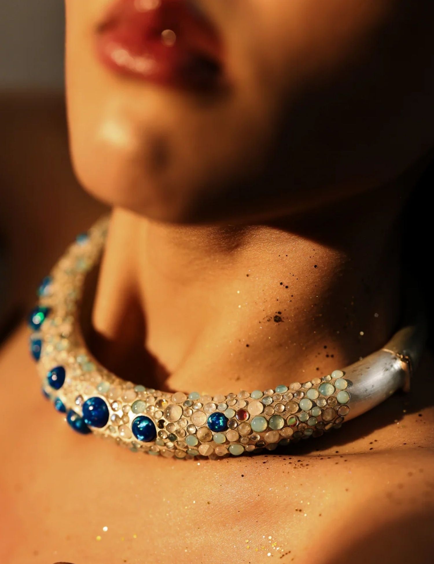 Model wearing blue opal hasli necklace close-up, warm skin tones