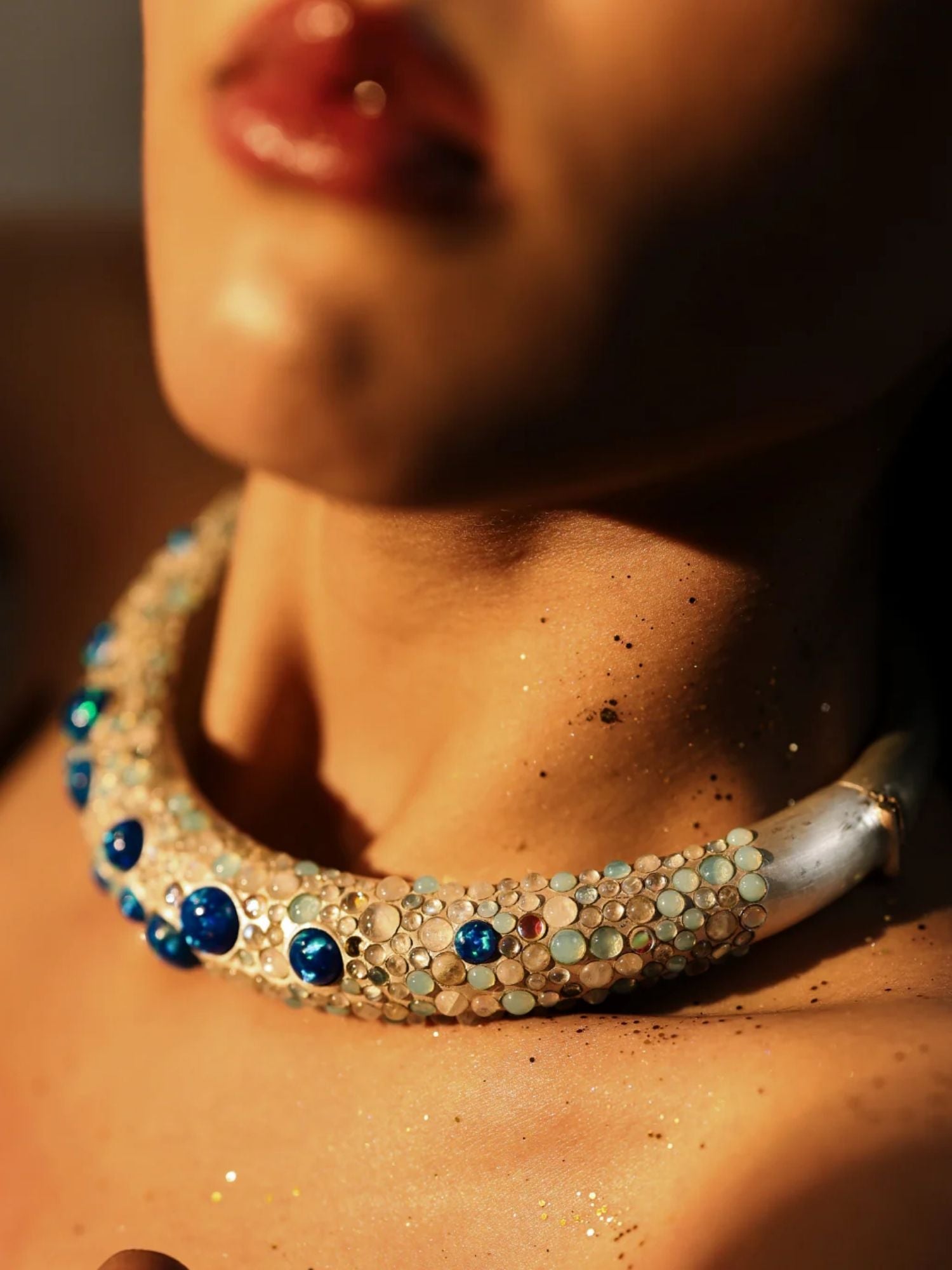 Model wearing blue opal hasli necklace close-up, warm skin tones