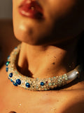 Model wearing blue opal hasli necklace close-up, warm skin tones