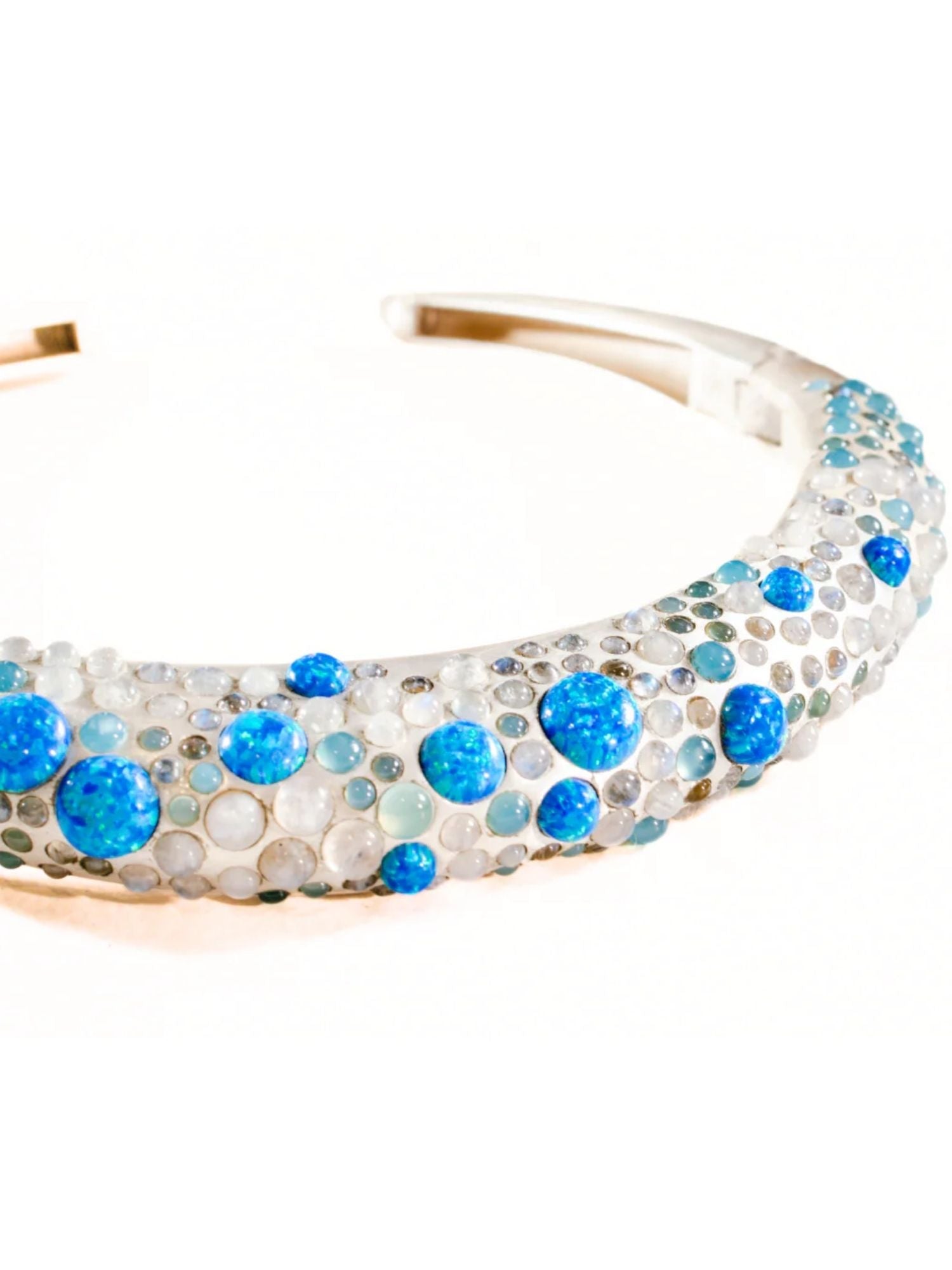 Angled product shot of silver hasli necklace with blue fire opal and aqua chalcedony