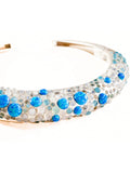 Angled product shot of silver hasli necklace with blue fire opal and aqua chalcedony