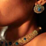 Side profile of model wearing blue opal spiral earring with hasli necklace visible
