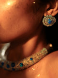 Side profile of model wearing blue opal spiral earring with hasli necklace visible