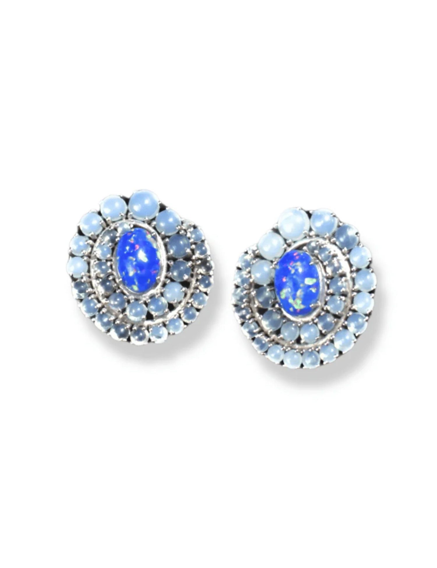 Pair of blue fire opal and moonstone spiral stud earrings on white background