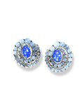 Pair of blue fire opal and moonstone spiral stud earrings on white background