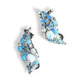 Pair of silver blue opal wave ear cuffs on white background