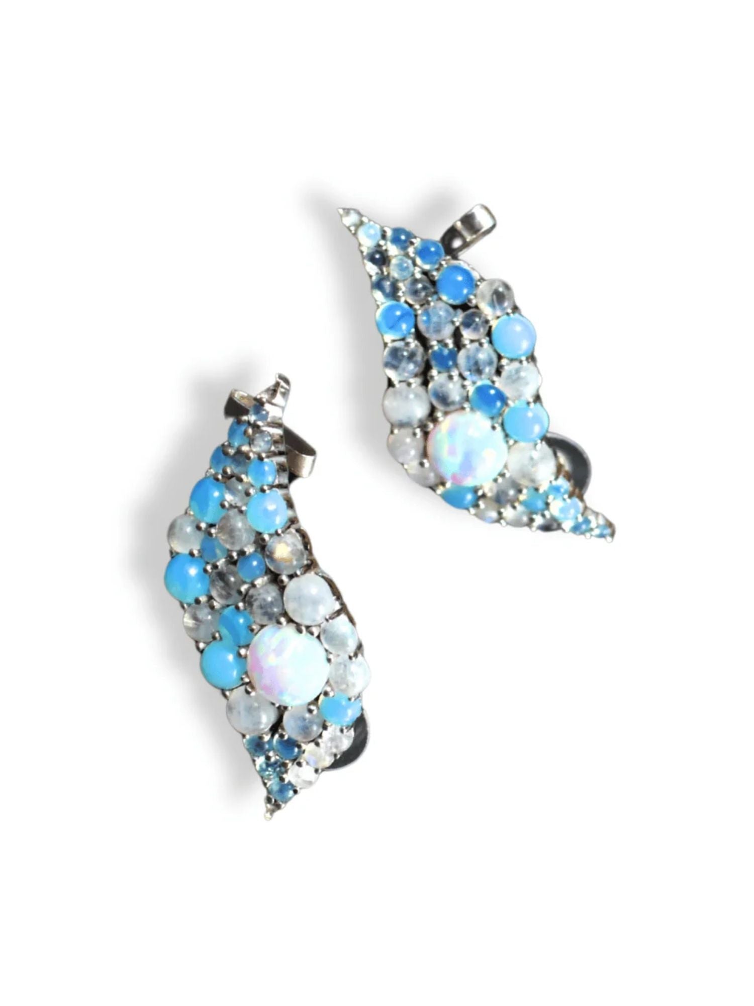 Pair of silver blue opal wave ear cuffs on white background