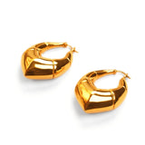 Two large gold claw earrings showing angular geometric form on white