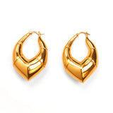 Pair of large geometric gold claw hoop earrings on white background