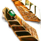 Close-up of green onyx and CZ earrings alongside collar necklace surface
