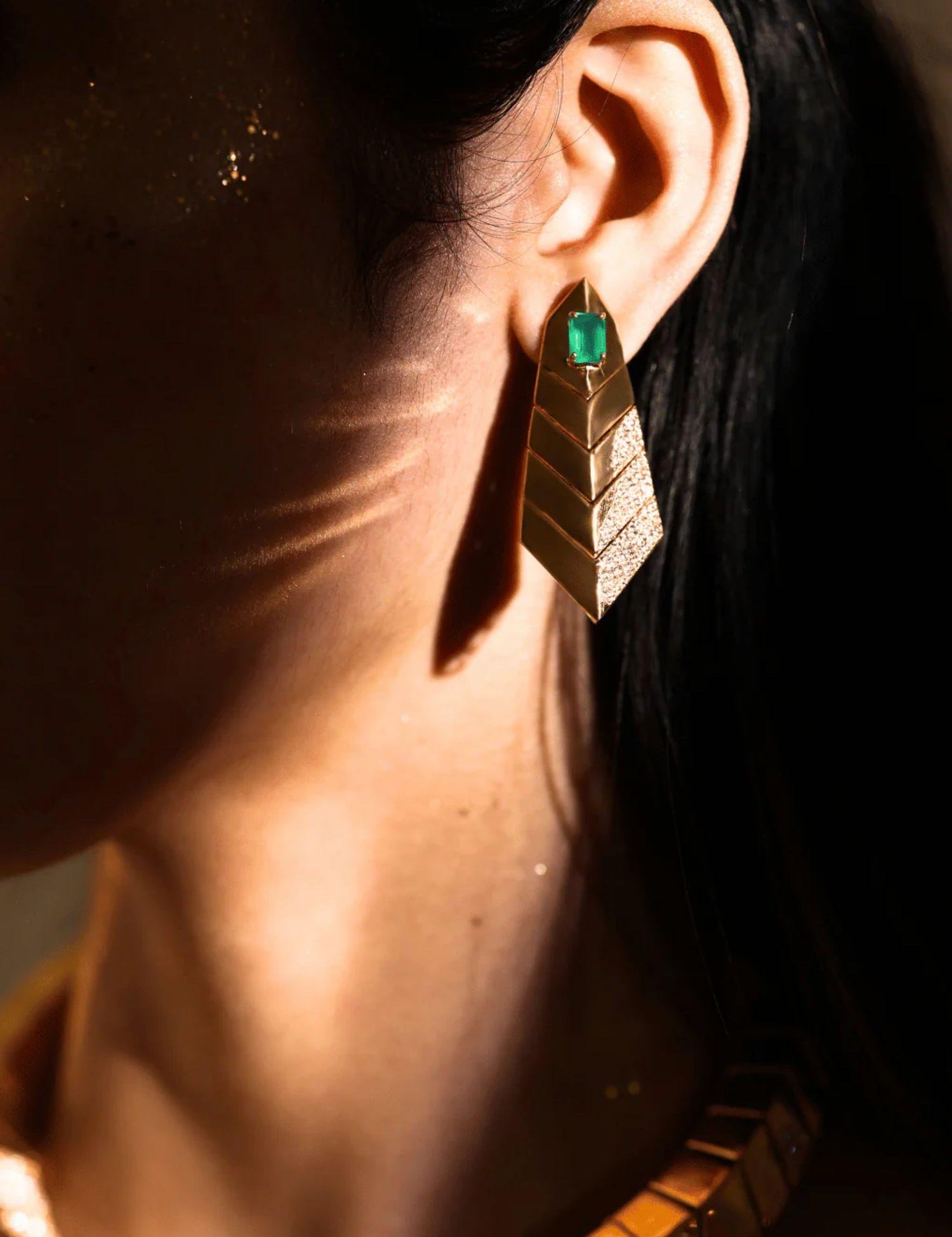 Model wearing green onyx gold earrings, side profile showing full drop length