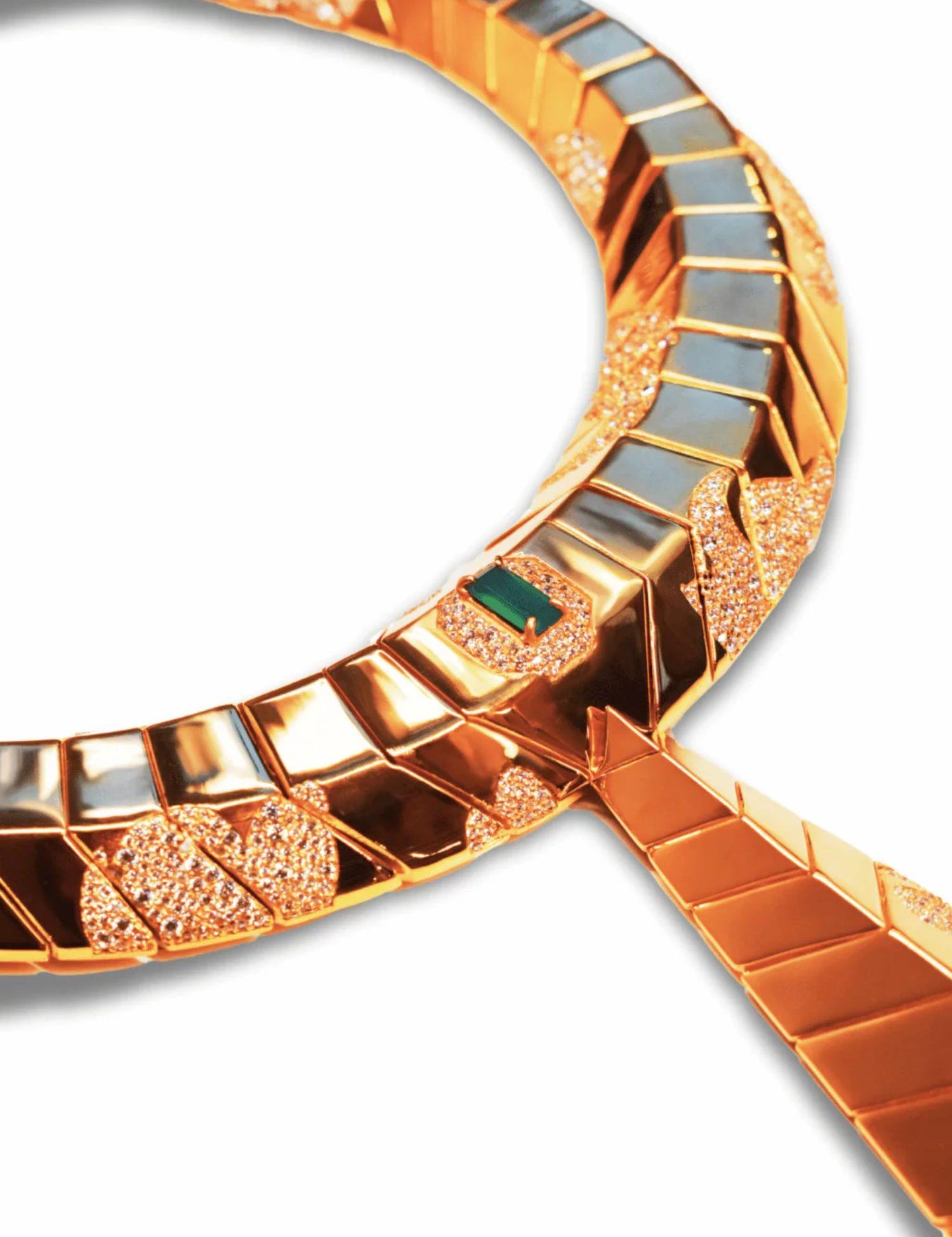 Close-up of hand-finished gold collar surface with green onyx stone and CZ detail