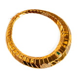 Front-facing product shot of sculptural gold collar necklace with tie pendant