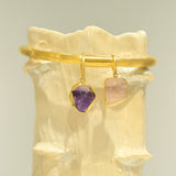 Gold choker with amethyst and rose quartz raw stone charms on clay prop