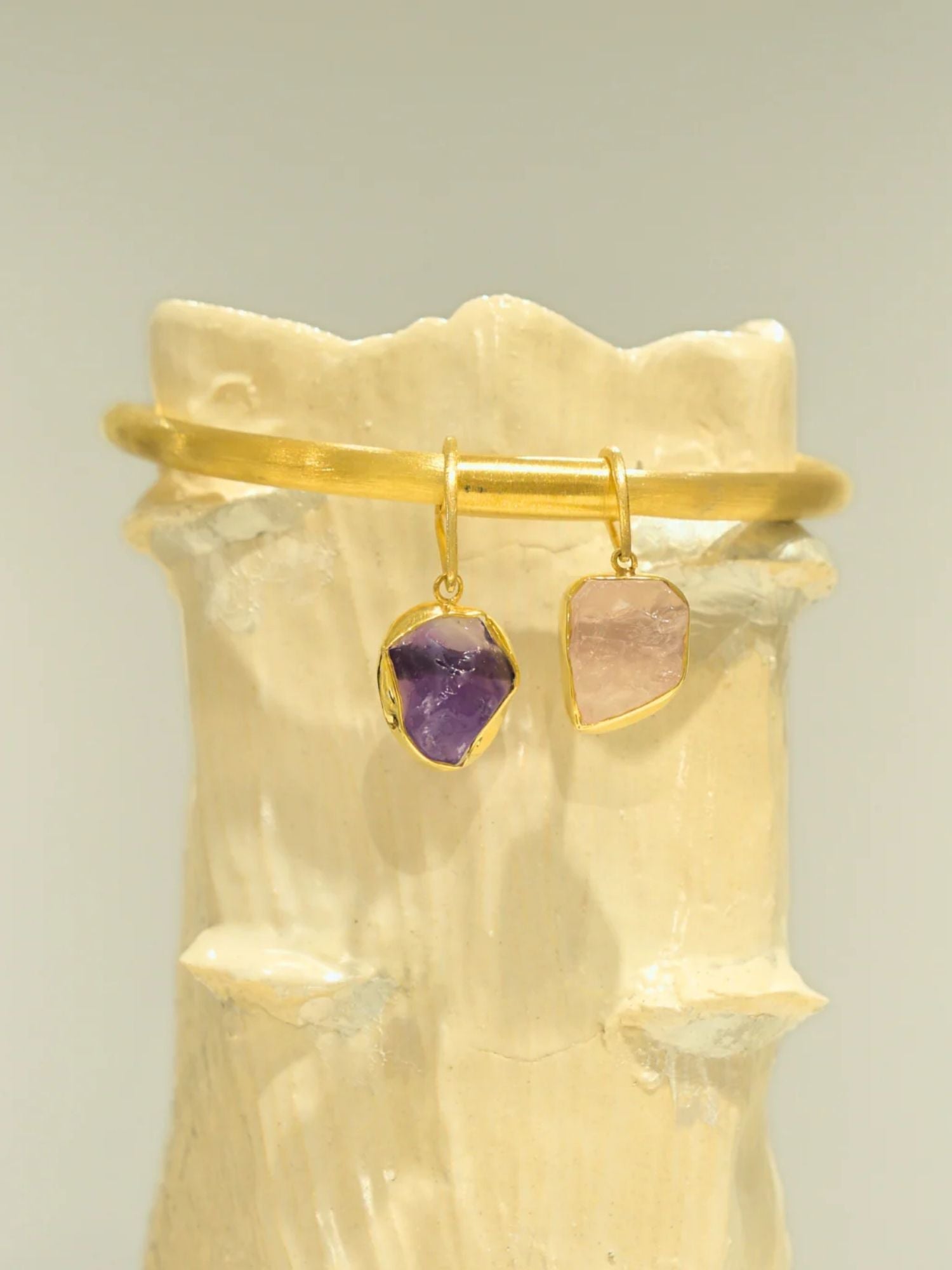 Gold choker with amethyst and rose quartz raw stone charms on clay prop