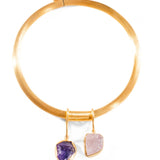 Gold choker bangle with two raw stone charm drops on white background