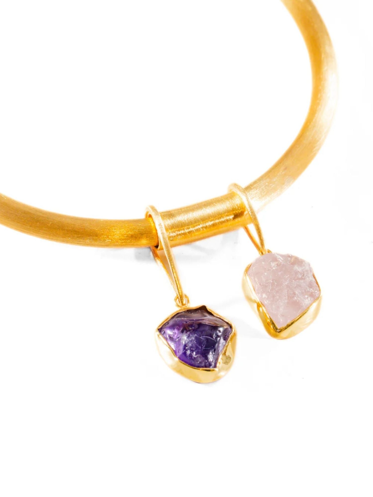 Overhead detail of gold choker bangle with two raw stone drops