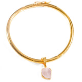 Gold bangle choker with raw rose quartz charm drop on white background