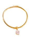 Gold bangle choker with raw rose quartz charm drop on white background