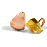 Rose quartz and citrine raw stone cocktail rings in gold setting on white