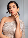 Model wearing gold cube earrings, hand near face in close portrait
