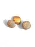 Detail shot of two gold cube earring variations showing dome and flat face