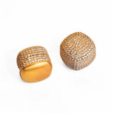 Pair of brushed gold cube earrings with CZ pave dome on white background