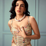 Model in ethnic attire wearing gold CZ dome ring and cube necklace