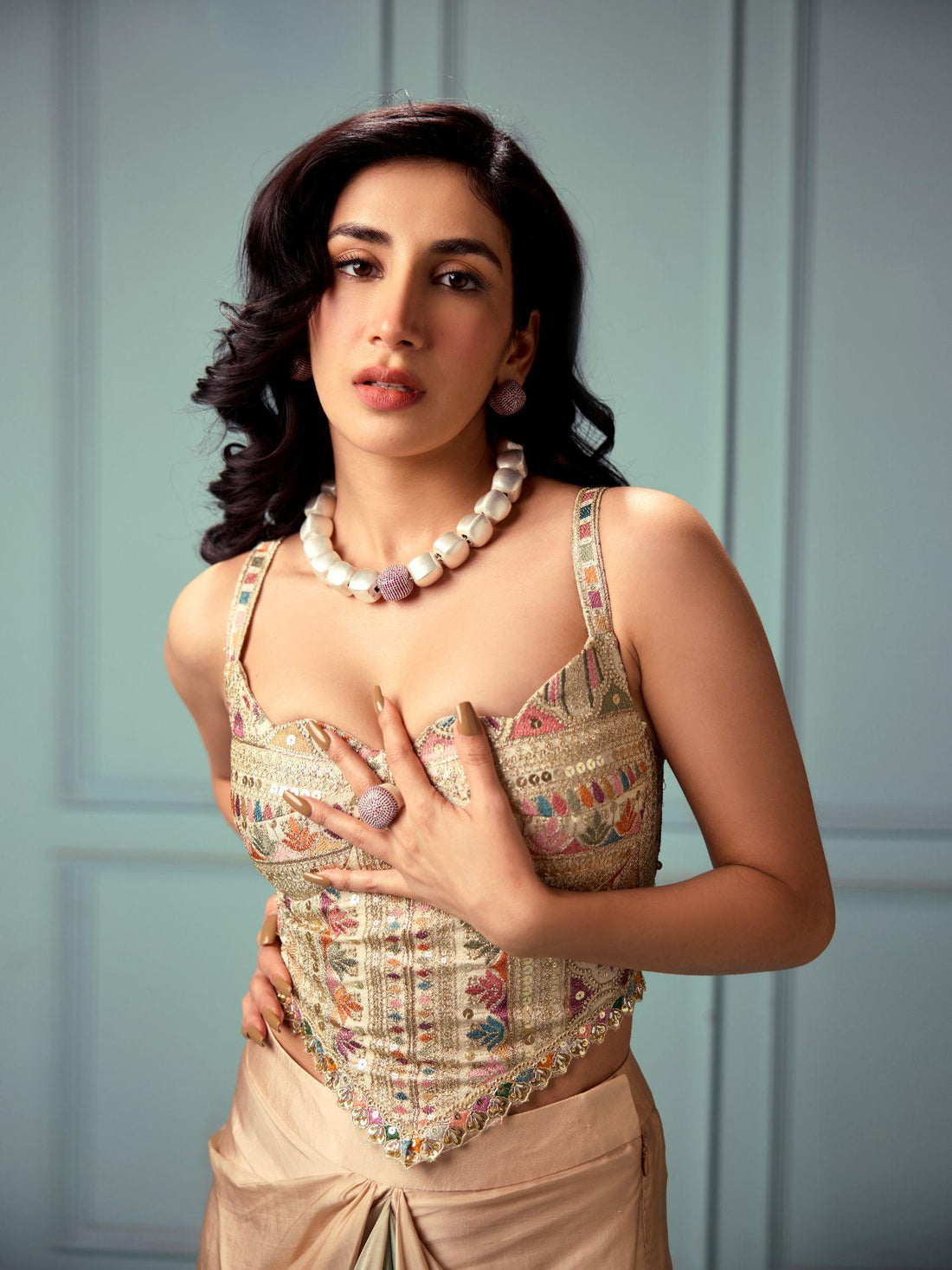 Model in ethnic attire wearing gold CZ dome ring and cube necklace