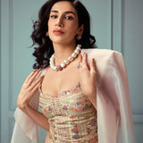 Model in ethnic dress wearing gold CZ dome ring and cube necklace