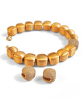 Gold cube necklace and earring set with CZ sphere on white background