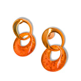 Pair of gold double-hoop earrings with lab-grown amber disc on white background