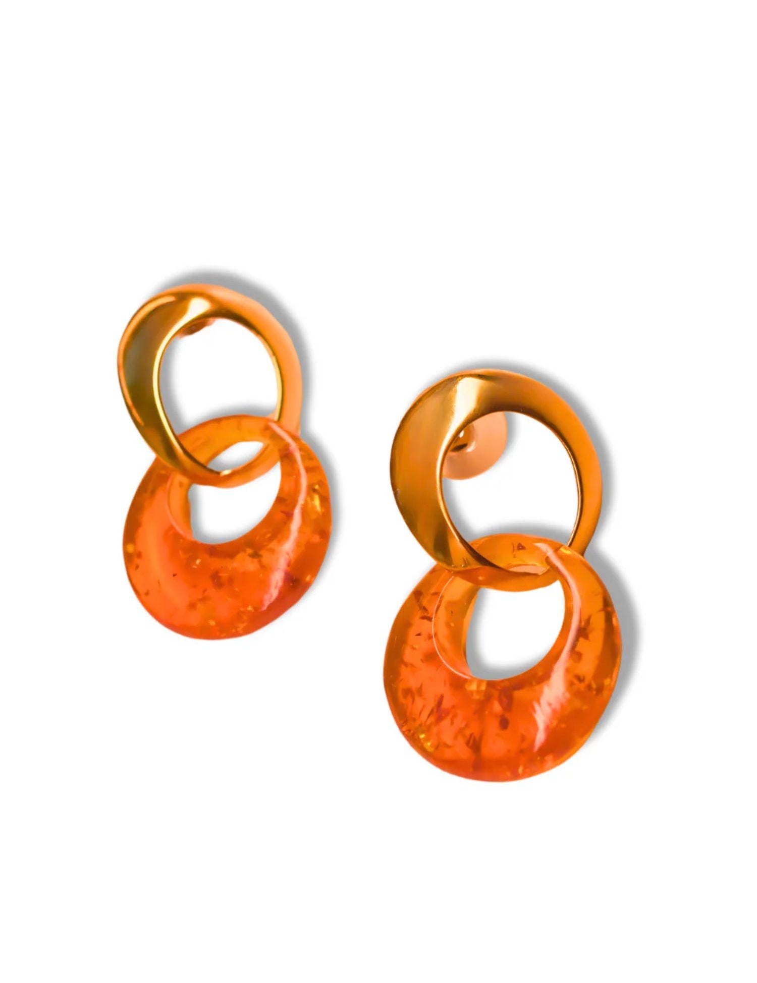 Pair of gold double-hoop earrings with lab-grown amber disc on white background