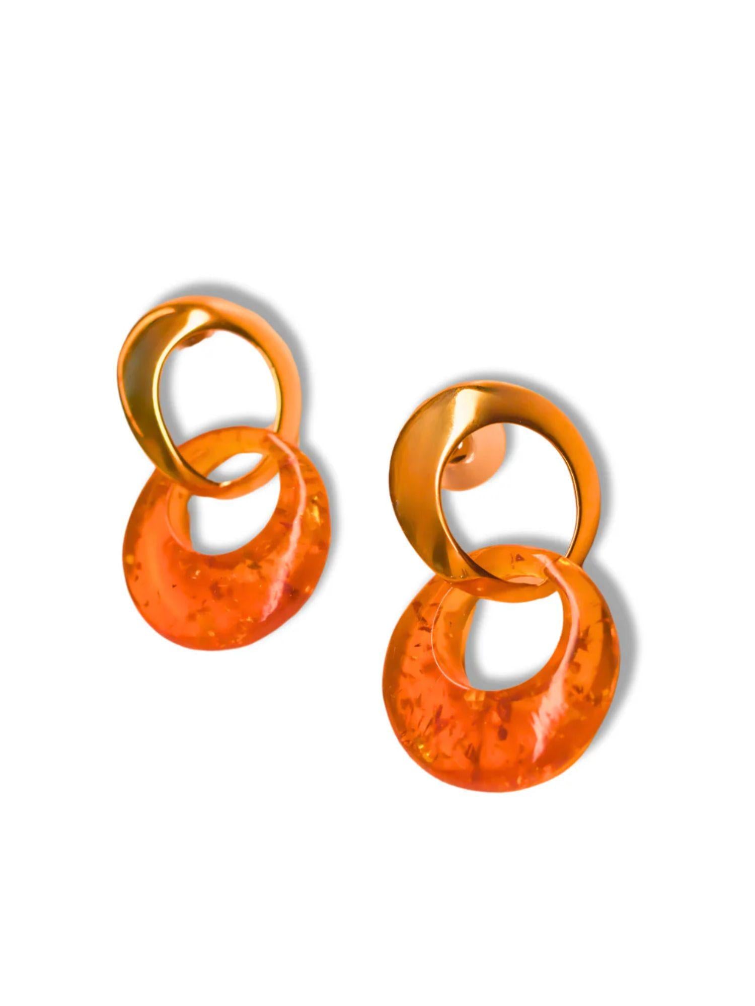 Pair of gold double-hoop earrings with lab-grown amber disc on white background