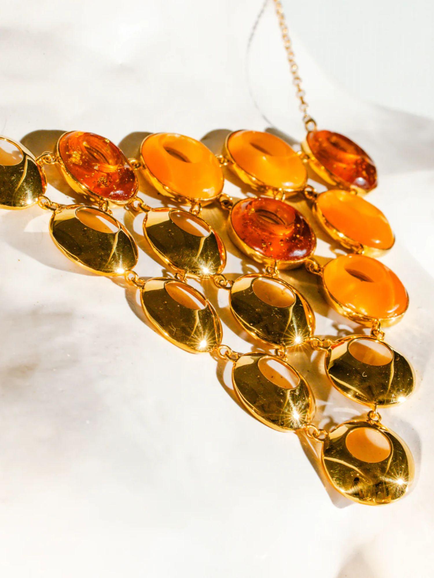 Close detail of triangular amber statement necklace with lab-grown amber and gold links